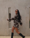 Brown plaid mini skirt by māre, featuring a stylish short design with a classic pattern and tailored fit.