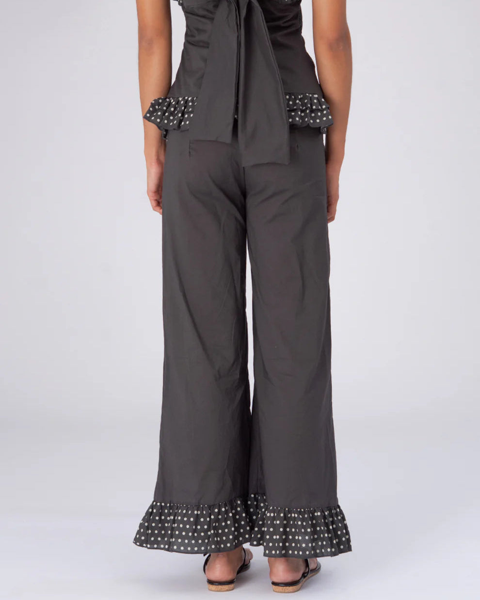 Brown polka dot pants by māre for Carmen Says, featuring a relaxed fit and stylish design, worn in a casual setting.