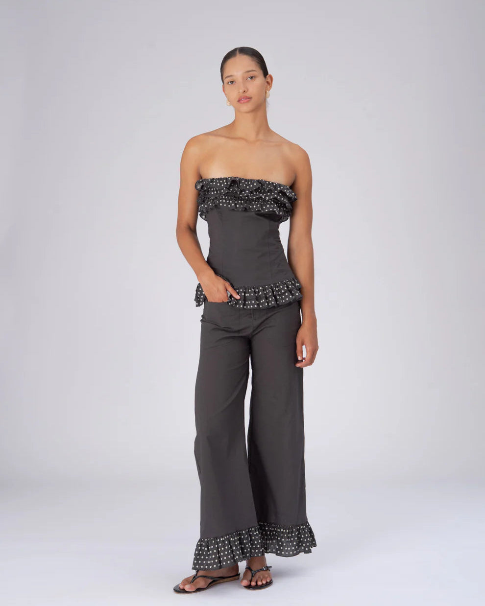 Night brown polka dot top by Carmen Says, featuring long sleeves and a relaxed fit, styled on a mannequin.