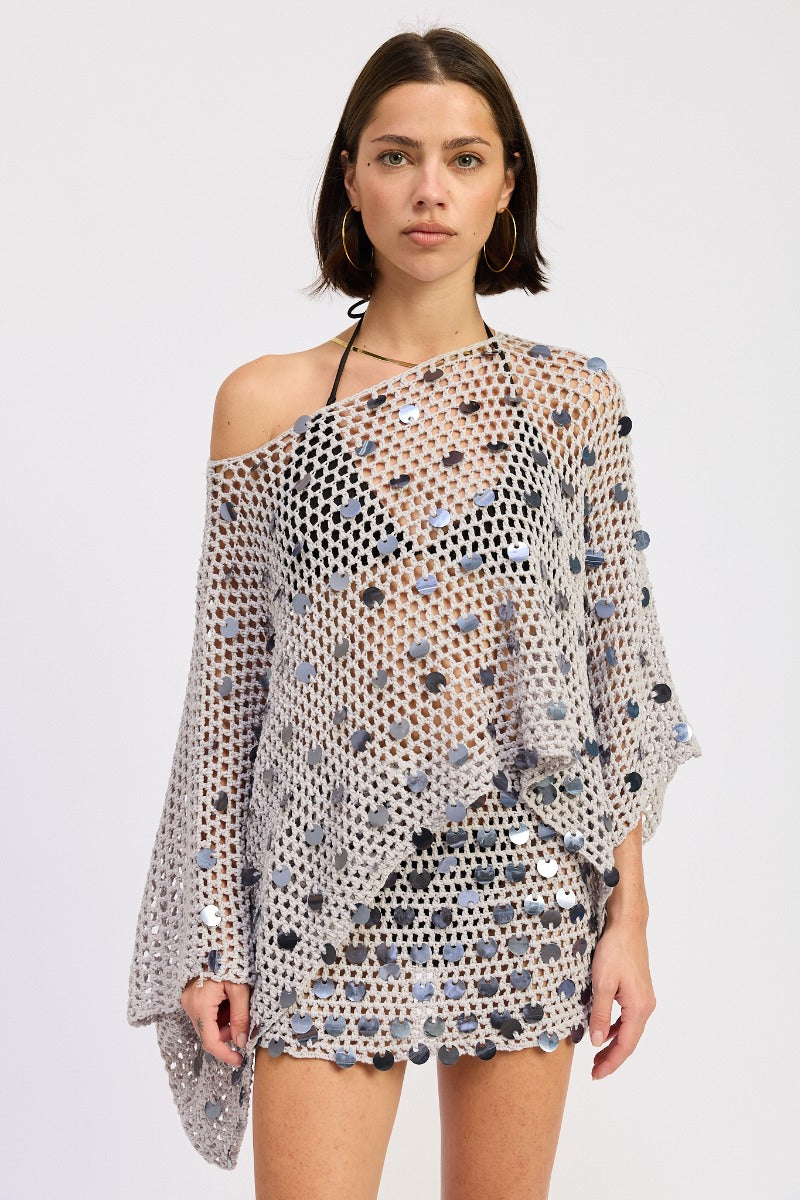 Pale blue silver poncho top by māre featuring lightweight fabric and relaxed fit, draped over a neutral background.